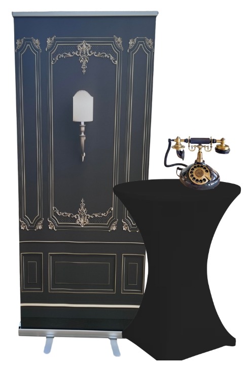 Black and gold ornate panel backdrop with a brass rotary telephone on a cocktail table