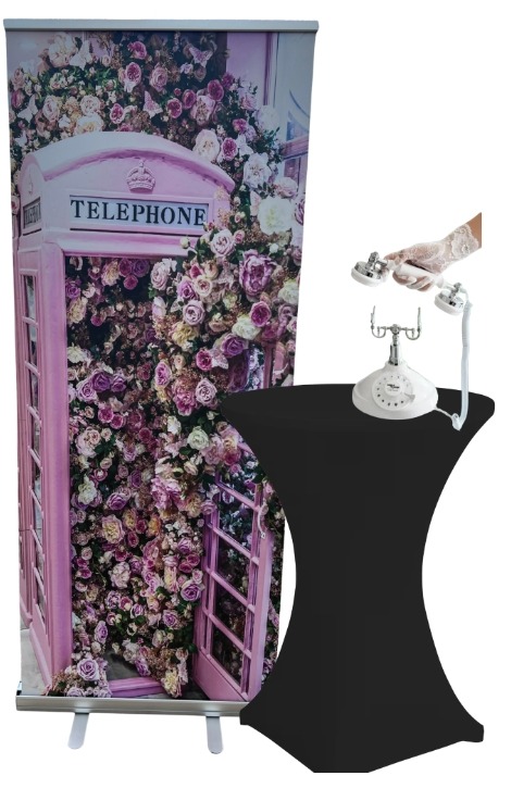 Pink floral telephone booth backdrop with a white vintage telephone on a cocktail table